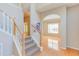 Staircase leading to the upper level, showcasing hardwood floors and an arched doorway at 413 Palafox Dr, Chapel Hill, NC 27516