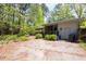 Backyard with concrete patio and lush greenery surrounding the home's exterior at 416 Colony Woods Dr, Chapel Hill, NC 27517