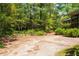View of the backyard that features an outdoor space perfect for entertaining with its lush greenery at 416 Colony Woods Dr, Chapel Hill, NC 27517