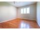 Bright bedroom with hardwood floors, neutral walls, and natural light from the window at 416 Colony Woods Dr, Chapel Hill, NC 27517