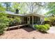 Charming exterior view of home with a ramp, screened porch, and lush landscaping at 416 Colony Woods Dr, Chapel Hill, NC 27517