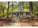 Charming single-story home with a stone walkway and surrounded by mature trees in a peaceful setting at 416 Colony Woods Dr, Chapel Hill, NC 27517