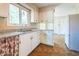Bright kitchen with white cabinetry, granite counters, and a view to the backyard at 416 Colony Woods Dr, Chapel Hill, NC 27517