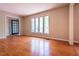 Bright living room with hardwood floors, large window, and black french doors at 416 Colony Woods Dr, Chapel Hill, NC 27517