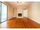 Open living room featuring hardwood flooring, fireplace, and sliding door for natural light at 416 Colony Woods Dr, Chapel Hill, NC 27517