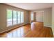 Inviting living room with hardwood floors, large windows, and neutral paint at 416 Colony Woods Dr, Chapel Hill, NC 27517