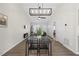 Open-concept dining room with a vaulted ceiling and contemporary light fixture at 42 Riverwalk Ter, Durham, NC 27704