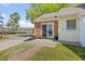Charming exterior featuring a brick facade, sliding glass door, and manicured lawn at 42 Riverwalk Ter, Durham, NC 27704