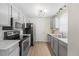 Modern kitchen with stainless steel appliances, grey cabinets, and marble countertops at 42 Riverwalk Ter, Durham, NC 27704