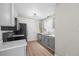 Modern kitchen with stainless steel appliances, grey cabinets, and marble countertops at 42 Riverwalk Ter, Durham, NC 27704