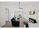Spacious living room with fireplace, sleek gray sofa, and adjacent dining area creates an open flow at 42 Riverwalk Ter, Durham, NC 27704
