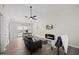 Spacious living room with fireplace, sleek gray sofa, and adjacent dining area creates an open flow at 42 Riverwalk Ter, Durham, NC 27704