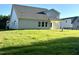 Expansive backyard featuring lush green grass and a covered patio connected to the house at 427 Earnest Way # L24, Kenly, NC 27542