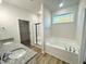 Bathroom showcasing double sink vanity with granite counters, shower, and soaking tub by window at 427 Earnest Way # L24, Kenly, NC 27542