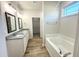 Bright bathroom featuring double vanity with granite countertops and a separate soaking tub at 427 Earnest Way # L24, Kenly, NC 27542