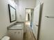 Bathroom with granite countertop vanity, and view of the staircase and a bedroom at 427 Earnest Way # L24, Kenly, NC 27542