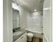 Well-lit bathroom with granite vanity top and a tub-shower combination with white tile surround at 427 Earnest Way # L24, Kenly, NC 27542