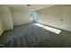 Bedroom features neutral carpet and walls, a window view to the backyard, and closet space at 427 Earnest Way # L24, Kenly, NC 27542