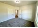 Bedroom with plush carpet, a window, and two doors; offering serene living space at 427 Earnest Way # L24, Kenly, NC 27542