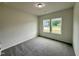 Bedroom with large window and carpeted floors at 427 Earnest Way # L24, Kenly, NC 27542