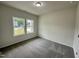 Bedroom with large window and carpeted floors at 427 Earnest Way # L24, Kenly, NC 27542