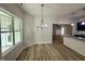 Bright dining area with wood floors, a modern chandelier, and a large window with lots of light at 427 Earnest Way # L24, Kenly, NC 27542