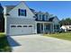 Charming home featuring a two-car garage and manicured lawn at 427 Earnest Way # L24, Kenly, NC 27542