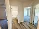 Hallway with access to tiled bath and bedroom, featuring wood-look vinyl floors at 427 Earnest Way # L24, Kenly, NC 27542