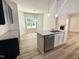 Bright kitchen features granite countertops, a stainless steel dishwasher, and wood-look flooring at 427 Earnest Way # L24, Kenly, NC 27542