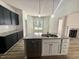 Bright kitchen features granite countertops, a stainless steel dishwasher, and wood-look flooring at 427 Earnest Way # L24, Kenly, NC 27542