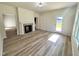 Open-concept living room featuring wood-look flooring and a cozy fireplace at 427 Earnest Way # L24, Kenly, NC 27542