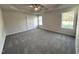 Spacious main bedroom with tray ceiling, ceiling fan, carpeted floor and large windows at 427 Earnest Way # L24, Kenly, NC 27542