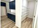 Spacious pantry features built-in shelving and dark blue cabinets with granite countertops at 427 Earnest Way # L24, Kenly, NC 27542