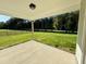 Covered patio overlooking a large, lush backyard with a view of surrounding trees and greenery at 427 Earnest Way # L24, Kenly, NC 27542