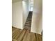 Bright staircase features hardwood floors at the base and leads upstairs to a bright landing at 427 Earnest Way # L24, Kenly, NC 27542