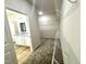 Spacious walk-in closet with custom shelving and carpet floor adjoins bathroom with granite vanity at 427 Earnest Way # L24, Kenly, NC 27542