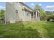 View of the home's backyard with green grass and a screened porch with brick foundation at 429 Gambit Cir, Wake Forest, NC 27587