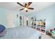 Comfortable bedroom with bright blue walls, ceiling fan, and decorated shelves at 429 Gambit Cir, Wake Forest, NC 27587