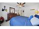 Cozy bedroom featuring hardwood floors, a ceiling fan, and tasteful nautical decor at 429 Gambit Cir, Wake Forest, NC 27587