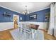 Traditional dining room featuring hardwood floors, white wainscoting, and a dark wood table with seating for six at 429 Gambit Cir, Wake Forest, NC 27587