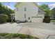 Spacious house featuring a two-car garage, manicured lawn, and inviting outdoor seating area at 429 Gambit Cir, Wake Forest, NC 27587