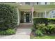 Close-up of front porch with brick steps, shrubs, and American flag waving at 429 Gambit Cir, Wake Forest, NC 27587