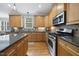 Well-lit kitchen with stainless steel appliances, granite countertops, and custom cabinets, offering both style and functionality at 429 Gambit Cir, Wake Forest, NC 27587