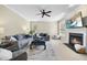 Spacious living room with a fireplace, comfortable seating, and large windows providing natural light, ideal for relaxation at 429 Gambit Cir, Wake Forest, NC 27587
