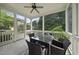 Inviting screened porch with wicker furniture, a ceiling fan, and views of lush greenery, perfect for relaxation at 429 Gambit Cir, Wake Forest, NC 27587