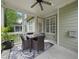 Cozy screened-in porch featuring wicker furniture, ceiling fan, and a stylish rug, creating a perfect outdoor retreat at 429 Gambit Cir, Wake Forest, NC 27587