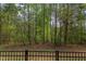 Fenced backyard with mature trees viewed from the deck creates a private retreat at 43 Turtle Point Bnd, Chapel Hill, NC 27516