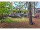 Exterior view of the home, showcases a spacious deck and backyard, great for outdoor living at 43 Turtle Point Bnd, Chapel Hill, NC 27516