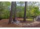 Shady backyard with mulch and rock path, mature trees, and patio at 43 Turtle Point Bnd, Chapel Hill, NC 27516