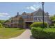 Spacious clubhouse with stone accents, upper-level balcony, and lush landscaping at 43 Turtle Point Bnd, Chapel Hill, NC 27516